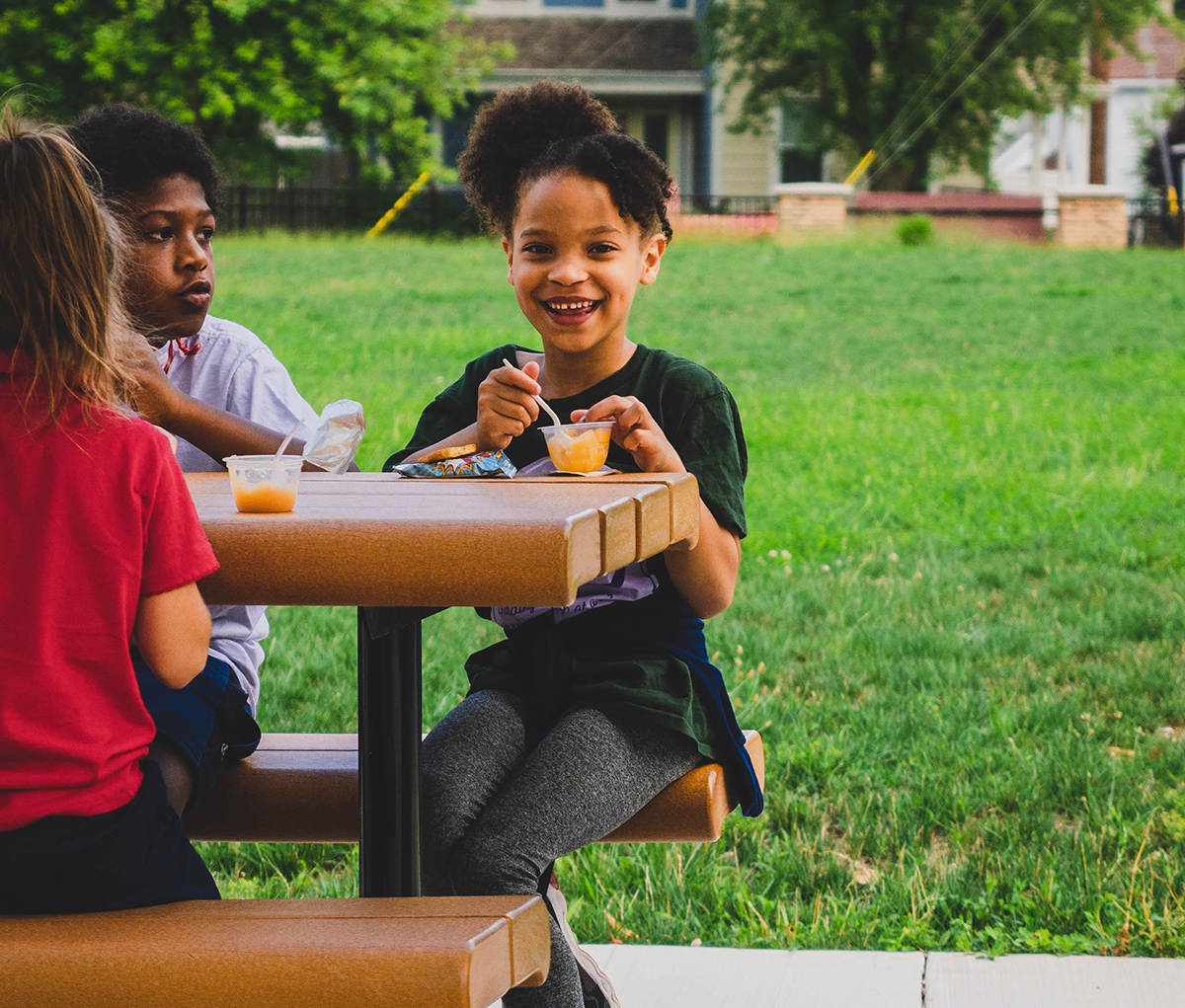 Young girl eating a snack and smiling